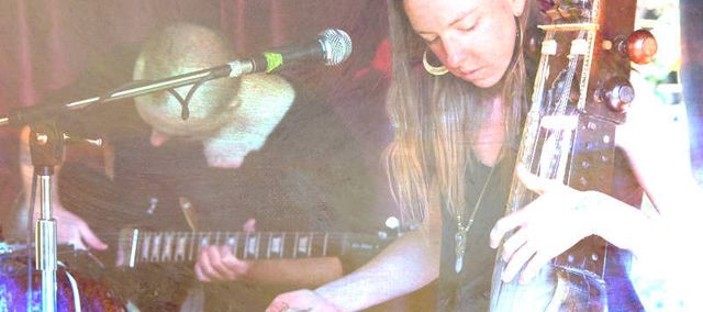 Maxwell Volume playing guitar and Jolanda Moyle playing sarangi.