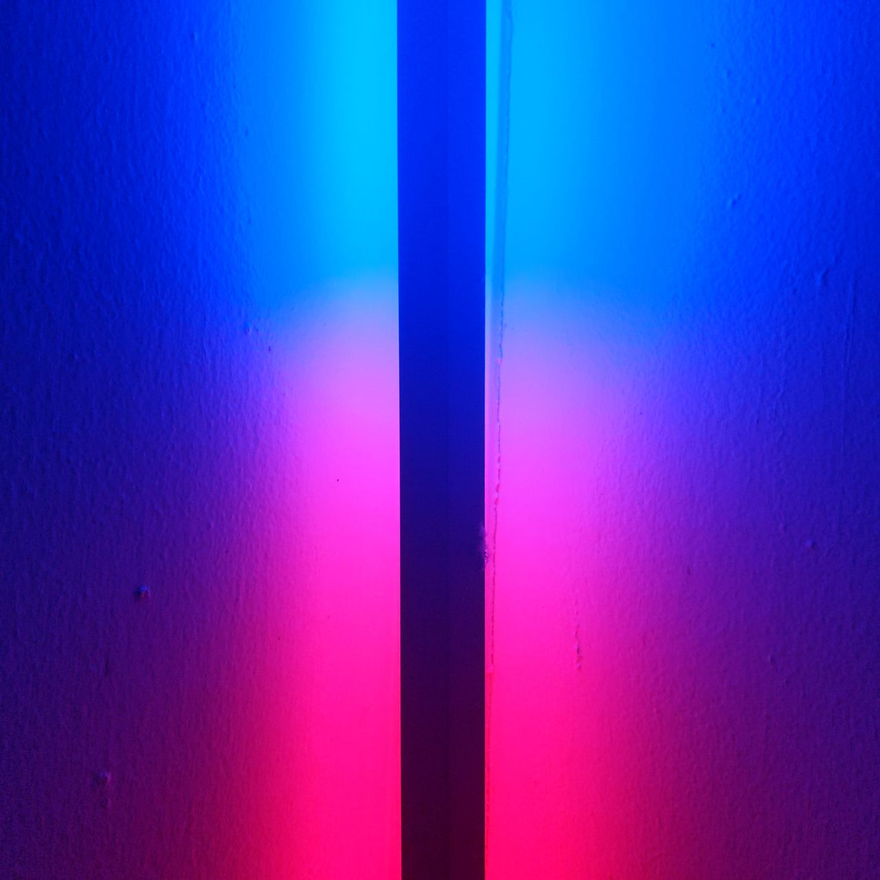 A dark line running through a blue and red light.
