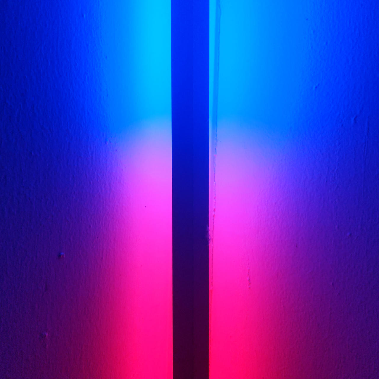 A dark line running through a blue and red light.
