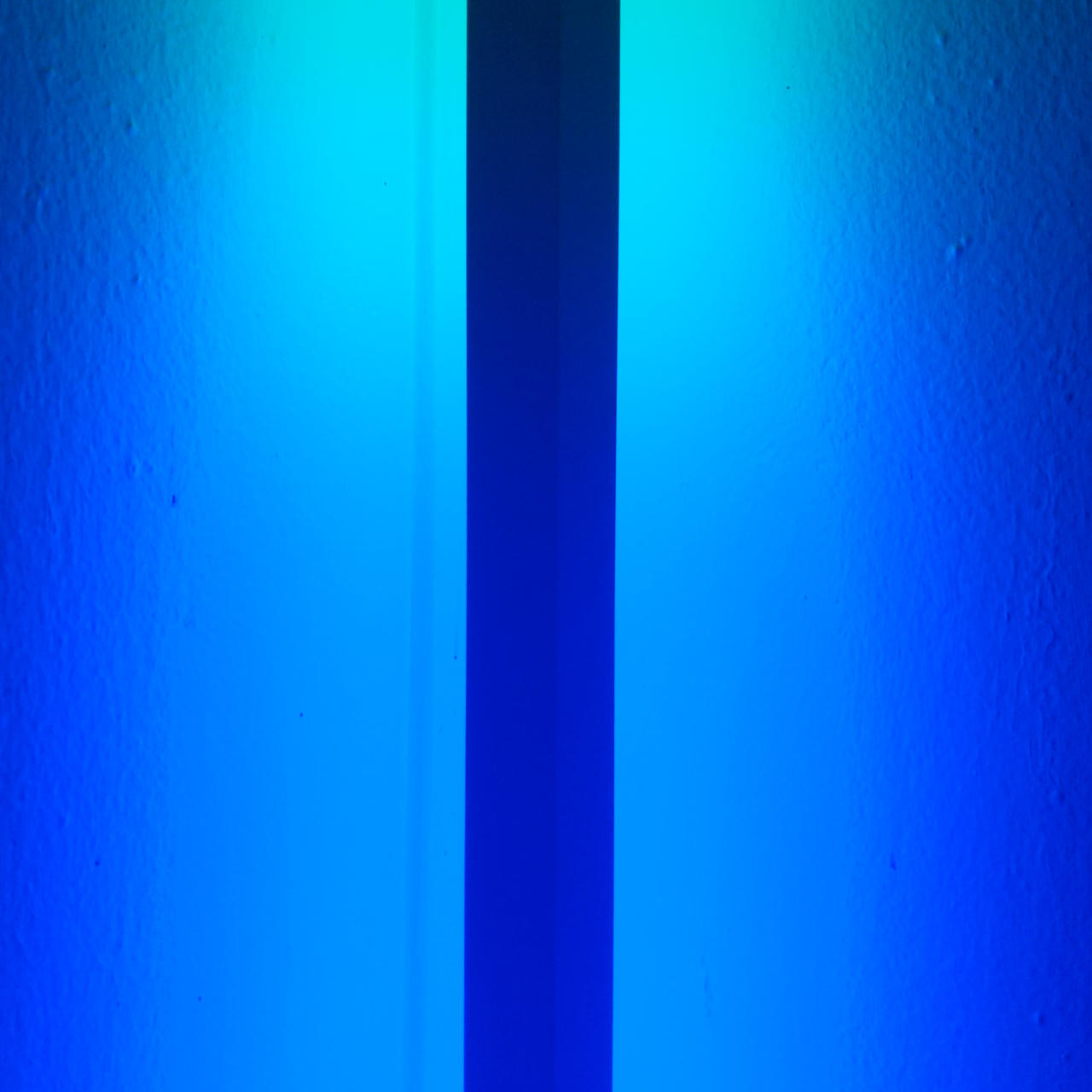 A dark line running through a blue light.